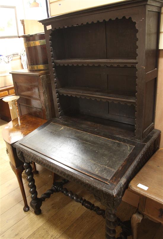 A late Victorian carved oak desk combined bookcase W.87cm